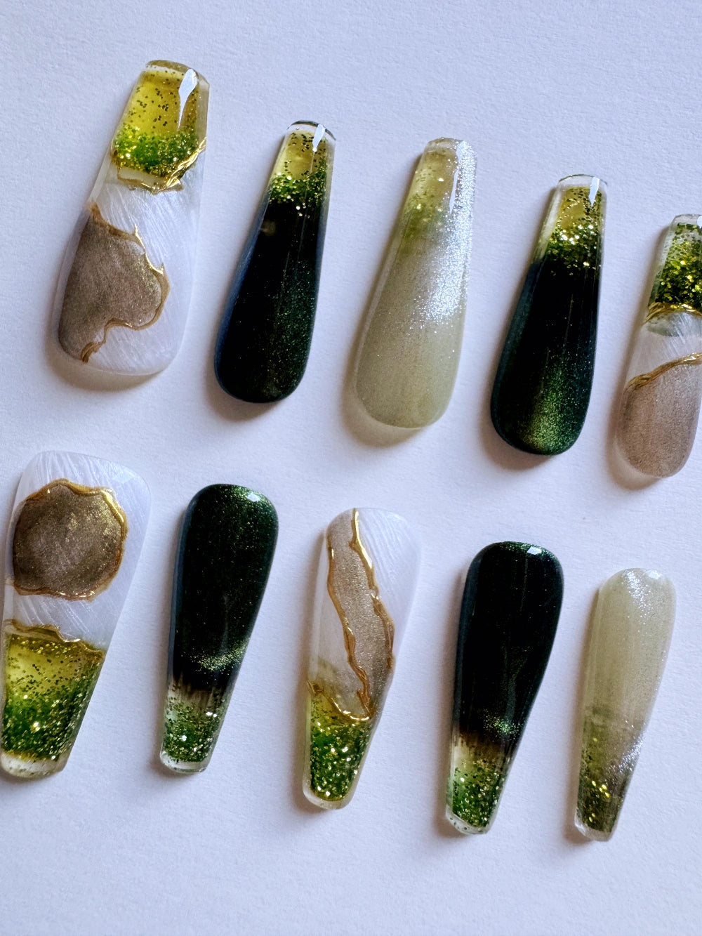 Emerald Pool Hand Drawn Elaborate Satin Gold Outline Emerald Cat Eye Flowing Sand Nail Art